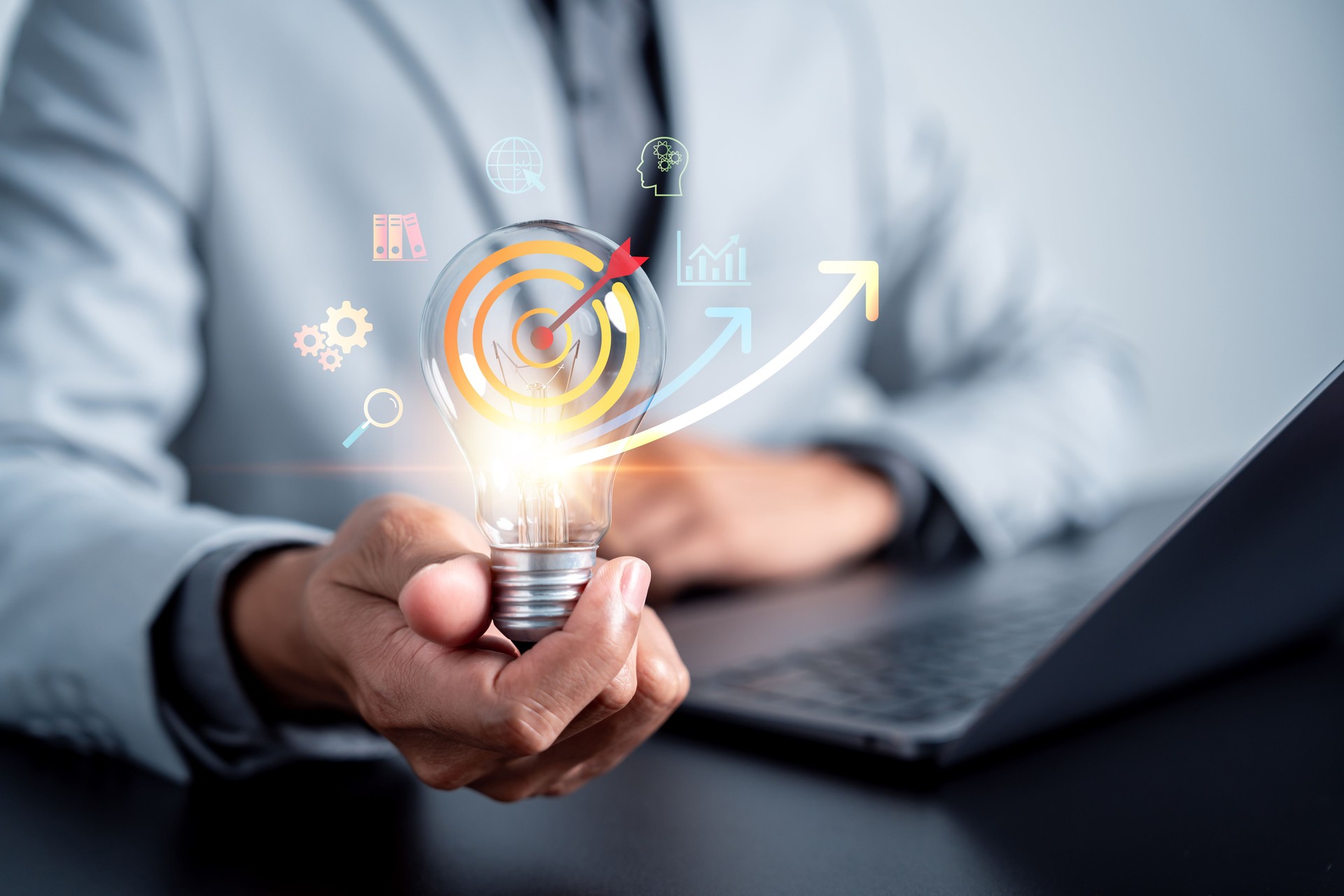 Business strategy with light bulb, target and growth arrows, innovation, planning, financial success, and goal achievement in digital economy.